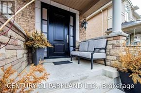 Vaughan (Vellore Village) townhouse for rent - A house entrance with a black door and a grey bench.
