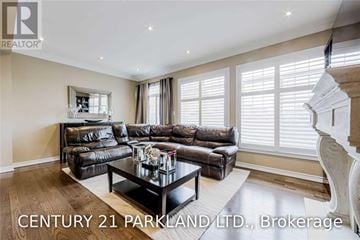 Vaughan (Vellore Village) townhouse for rent - A living room with a black leather sofa and a glass coffee table.