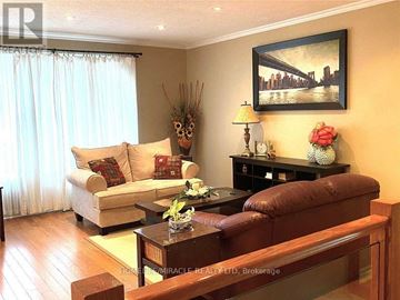 Mississauga (Streetsville) apartment for rent - A living room with a brown couch, a coffee table, and a painting on the wall.