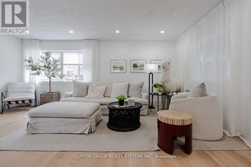 Oakville (Br Bronte) apartment for rent - A living room with white furniture and a tree in a pot.