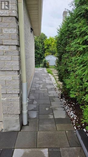 Newmarket (Bristol-London) apartment for rent - A grey stone wall with a metal pipe running along it.