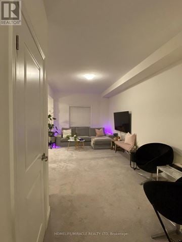 Brant (Paris) townhouse for rent - A living room with a grey couch and a black chair.