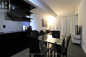 Toronto (Bay Street Corridor) condo for rent - A modern kitchen with a glass table and black chairs.