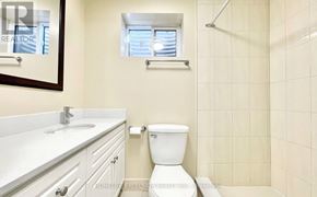 Toronto (Agincourt South-Malvern West) apartment for rent - A white toilet in a bathroom with a white sink and a window.