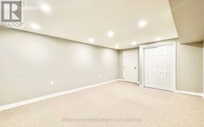 Toronto (Agincourt South-Malvern West) apartment for rent - A spacious room with a carpeted floor and two doors.