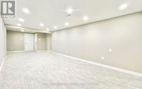 Toronto (Agincourt South-Malvern West) apartment for rent - A spacious room with a carpeted floor and two doors.