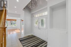 Richmond Hill (Jefferson) apartment for rent - A white interior of a house with a chandelier and a striped rug.