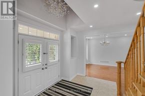 Richmond Hill (Jefferson) apartment for rent - A white interior with a chandelier and a wooden staircase.