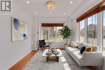 Richmond Hill (Jefferson) apartment for rent - A modern living room with a grey sofa, a coffee table, and a large painting on the wall.