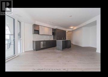 Toronto (Banbury-Don Mills) condo for rent - A modern kitchen with dark wood cabinets and a white countertop.