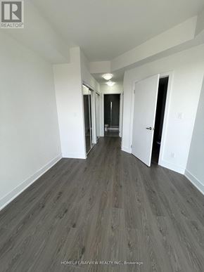 Toronto (Banbury-Don Mills) condo for rent - A long hallway with wood floors and white walls.