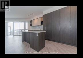 Toronto (Banbury-Don Mills) condo for rent - A modern kitchen with wooden cabinets and a countertop.