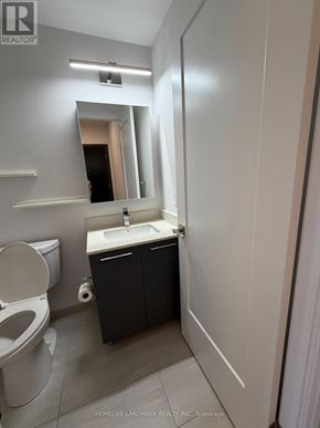 Markham (Unionville) condo for rent - A bathroom with a toilet, sink, and mirror.