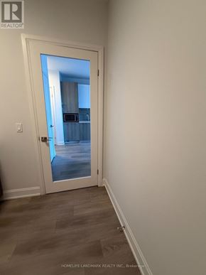 Markham (Unionville) condo for rent - A white door with a glass window leading to a hallway.