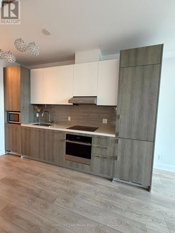Markham (Unionville) condo for rent - A modern kitchen with wooden cabinets and a stainless steel oven.