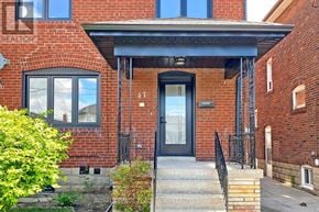 Toronto (Briar Hill-Belgravia) apartment for rent - A red brick house with a black door and windows.