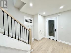 Toronto (Briar Hill-Belgravia) apartment for rent - A white interior with a staircase and a door.