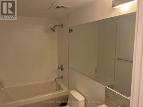 Toronto (Bay Street Corridor) condo for rent - A white bathroom with a toilet, sink, and shower.