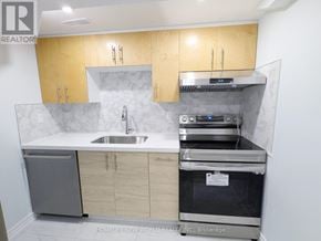 Toronto (Greenwood-Coxwell) apartment for rent - A kitchen with wooden cabinets and a stainless steel dishwasher.