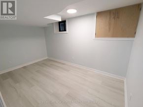 Toronto (Greenwood-Coxwell) apartment for rent - A room with a wooden floor and a window with blinds.