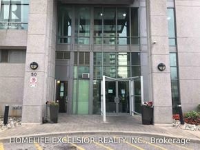Toronto (Bendale) condo for rent - The entrance to a building with the sign "HOMELIFE EXCELSIOR REALTY INC., Brokerage" on the ground.