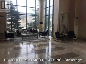 Toronto (Bendale) condo for rent - A living room with a large window and a view of trees and a building outside.