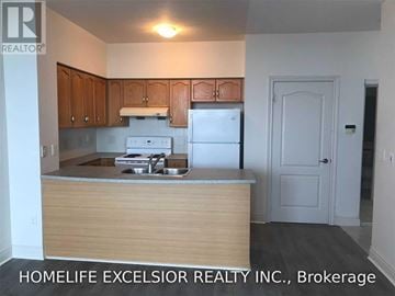 Toronto (Bendale) condo for rent - A kitchen with wooden cabinets and a white fridge.