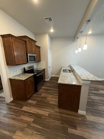 Temple triplex for rent - A kitchen with wooden cabinets and a granite countertop.