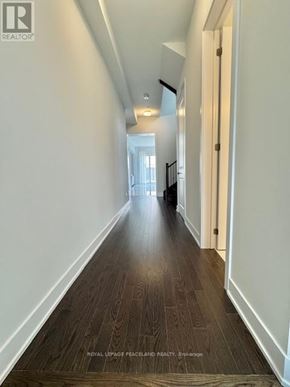 Aurora apartment for rent - A long hallway with wood floors and white walls.
