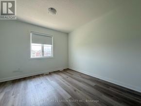 Milton (Bw Bowes) townhouse for rent - A room with a window and wooden flooring.