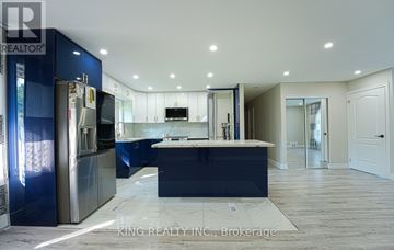 Toronto (Victoria Village) apartment for rent - A modern kitchen with blue cabinets and a central island.