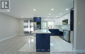 Toronto (Victoria Village) apartment for rent - A kitchen with a blue island and wooden floors.