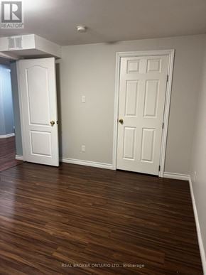 Barrie (Letitia Heights) apartment for rent - A room with two white doors and wood flooring.