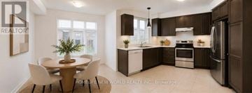 Newmarket (Woodland Hill) townhouse for rent - A modern kitchen with dark brown cabinets and white appliances.