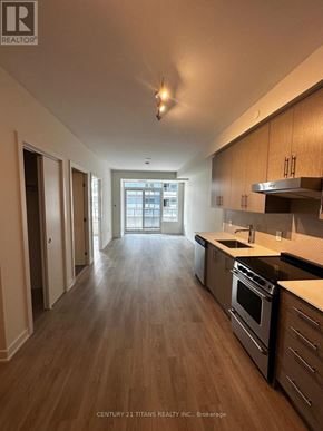 Hamilton (Beasley) condo for rent - A kitchen with wooden floors and stainless steel appliances.