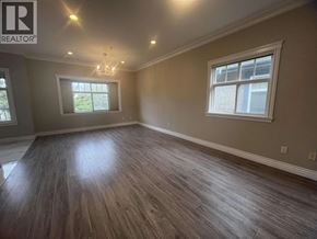 Vancouver apartment for rent - A room with wooden flooring and a chandelier.