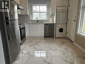 Vancouver apartment for rent - A kitchen with a marble floor and white cabinets.