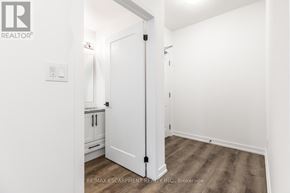 Hamilton (Waterdown) condo for rent - A white door in a room with a wooden floor.