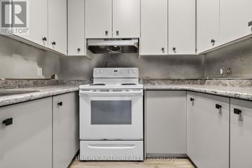Toronto (Moss Park) multi-family for rent - A white oven is in a kitchen with white cabinets.