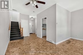 Toronto (Moss Park) multi-family for rent - A room with a staircase and a ceiling fan.