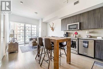 Toronto (Mimico) condo for rent - A modern kitchen with a wooden table and chairs.