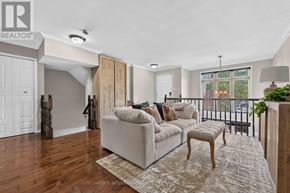 Ottawa condo for rent - A well-lit living room with a couch, a chair, and a rug.
