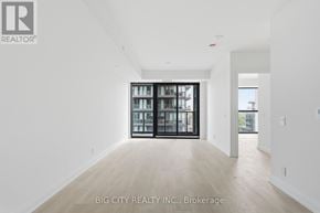 Toronto (Thorncliffe Park) condo for rent - A spacious room with a view of the city through a large window.