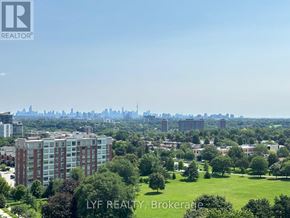 Toronto (Humber Heights) condo for rent - A cityscape with a green field in the foreground and apartment buildings in the middle ground.