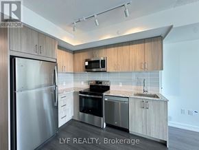 Toronto (Humber Heights) condo for rent - A modern kitchen with wooden cabinets and stainless steel appliances.