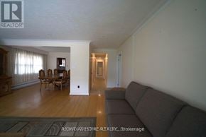 Toronto (Humberlea-Pelmo Park) apartment for rent - A living room with a couch and a dining table.