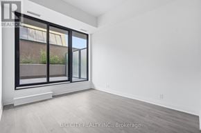 Toronto (Thorncliffe Park) condo for rent - A room with a large window and a sliding door.