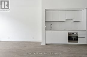Toronto (Thorncliffe Park) condo for rent - A white kitchen with a stove top oven and cabinets.