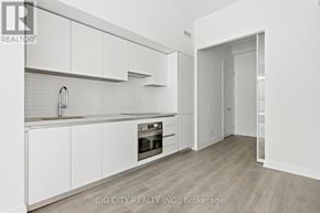 Toronto (Thorncliffe Park) condo for rent - A white kitchen with a sink and cabinets.