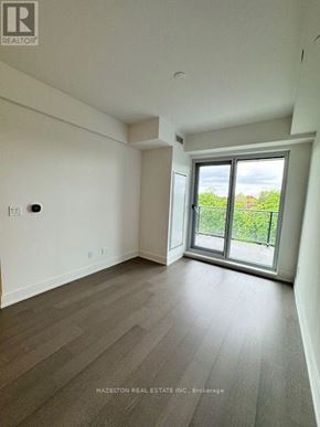 Toronto (Yonge-Eglinton) condo for rent - A room with a sliding glass door leading to a green area outside.